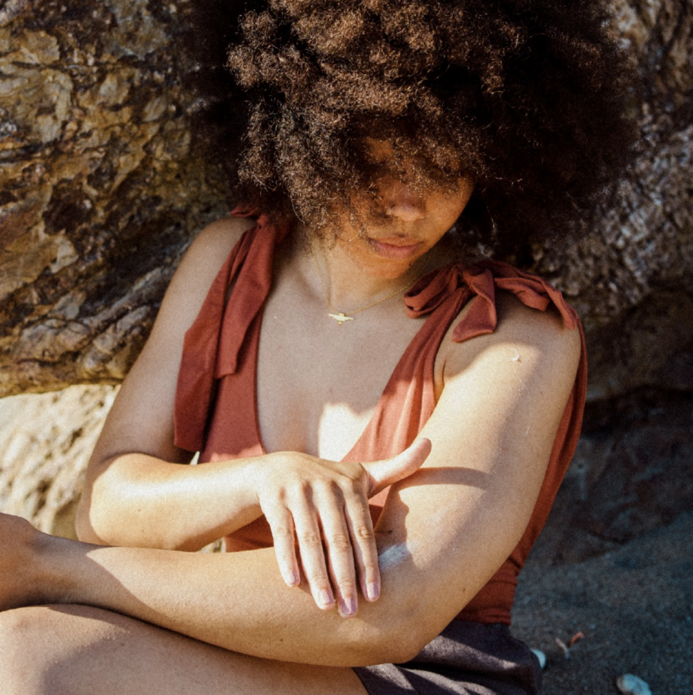 woman applying skincare product to arm